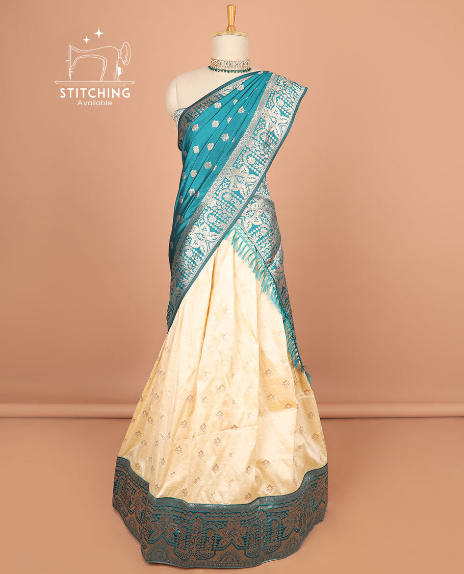 Cream buttas half saree with contrast zari design border, zari design blouse & light blue floral zari design dhavani