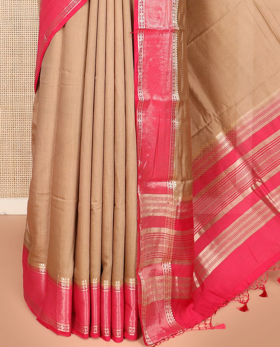 Light Brown Plain Assam Silk Saree, Complemented by a Contrast Traditional Zari Design Border of Rudraksha Motifs, a Gleaming Pallu of Zari Stripes, and Paired with a Contrast Blouse