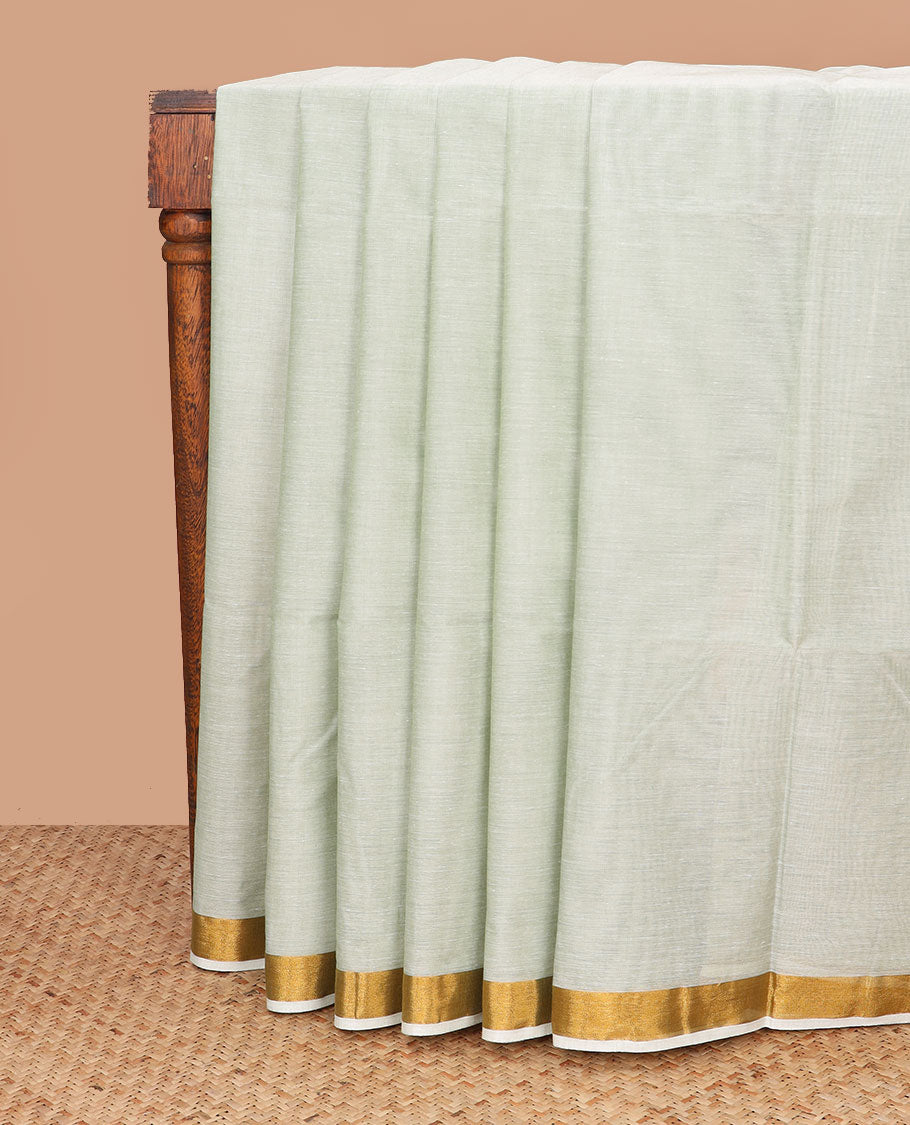 Pale green plain jute cotton saree, zari bavanji border, and striped pallu