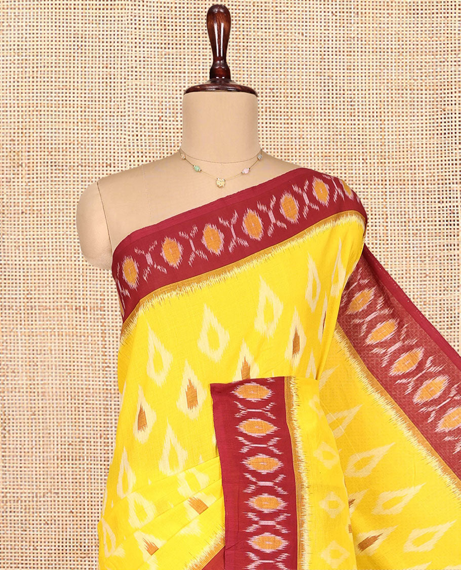 Yellow Ikkat Cotton Saree, Adorned with Ikkat Buttas All Over Its Body, Complemented by a Contrast Border of Ikkat Buttas, Chevron Striped Pallu, and Has No Blouse