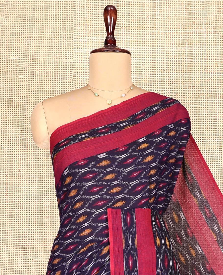 Blue Ikkat Cotton Saree, Adorned with Ikkat-Style Ogee Patterns on Its Body, Complemented by Contrast Ikkat-Style Border, Pallu Steeped with Ikkat Buttas, and Has No Blouse