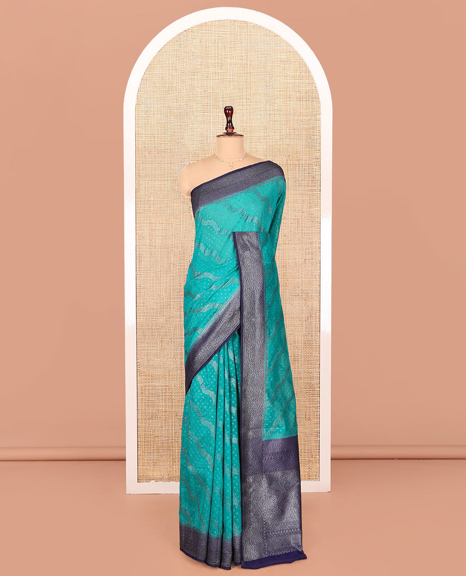 Blue Georgette Saree, Subtly Highlighted with Buttas and Diagonal Zig-Zag Stripes on Its Body, Complemented by a Contrast Gleaming Zari Textured Border, Pallu Adorned with Zari Designs, and Paired with a Contrast Blouse