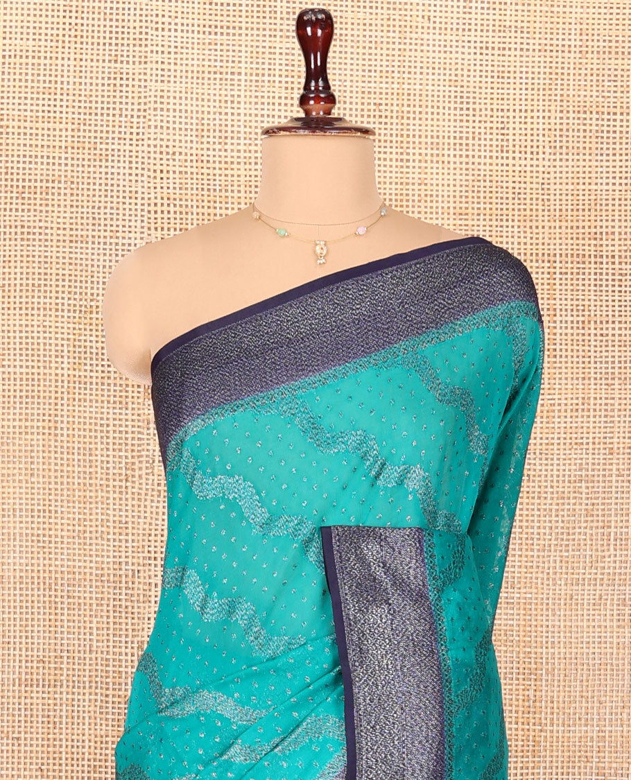 Blue Georgette Saree, Subtly Highlighted with Buttas and Diagonal Zig-Zag Stripes on Its Body, Complemented by a Contrast Gleaming Zari Textured Border, Pallu Adorned with Zari Designs, and Paired with a Contrast Blouse