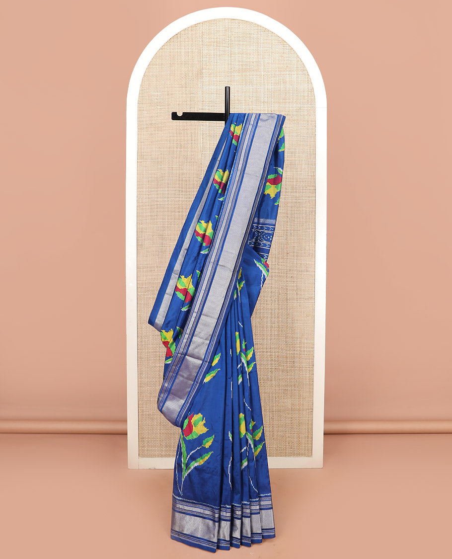 Blue Ikkat Silk Saree Colourfully Woven in Floral Buttas Across the Body, Featuring a Zari Border, a Pallu Adorned with Ikkat Weave, and Paired with a Matching Blouse