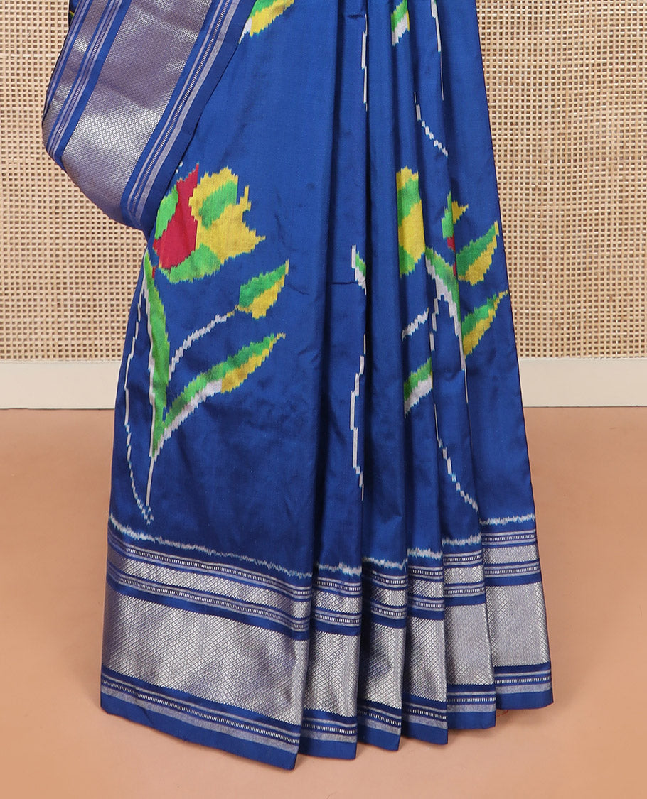 Blue Ikkat Silk Saree Colourfully Woven in Floral Buttas Across the Body, Featuring a Zari Border, a Pallu Adorned with Ikkat Weave, and Paired with a Matching Blouse
