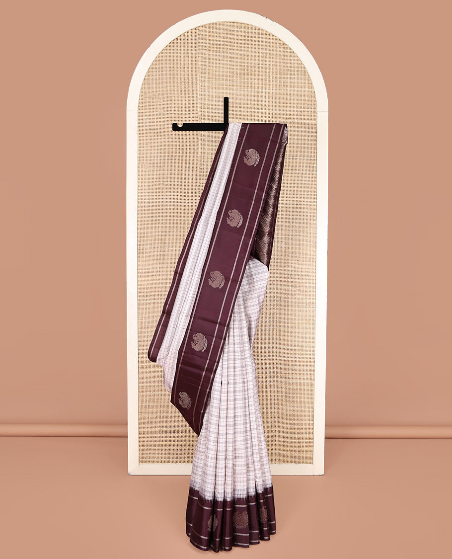 Off-white Kanchipuram Silk Saree, Subtly Sparkled with Checked Design On Its Body, Complemented by Contrast Border of Banaras and Annam Designs, Pallu of Diagonal Rekku Designs, and Paired with a Contrast Blouse