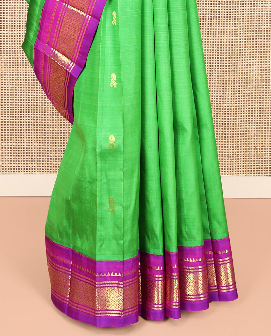 Green Kanchipuram Silk Saree, Adorned with Zari Buttas, Complemented by a Contrast One-Sided Korvai Border of Rekku, Banaras, and Jaal Designs, Zari Design Pallu, and No Blouse