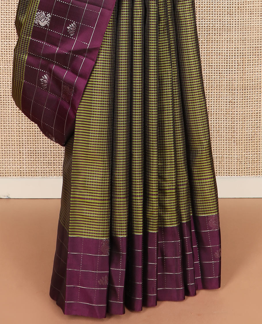 Green stripes and muthu striped Kanchipuram silk saree, contrast border of mayil and lotus butta enclosed checks, and intricate jaal pallu