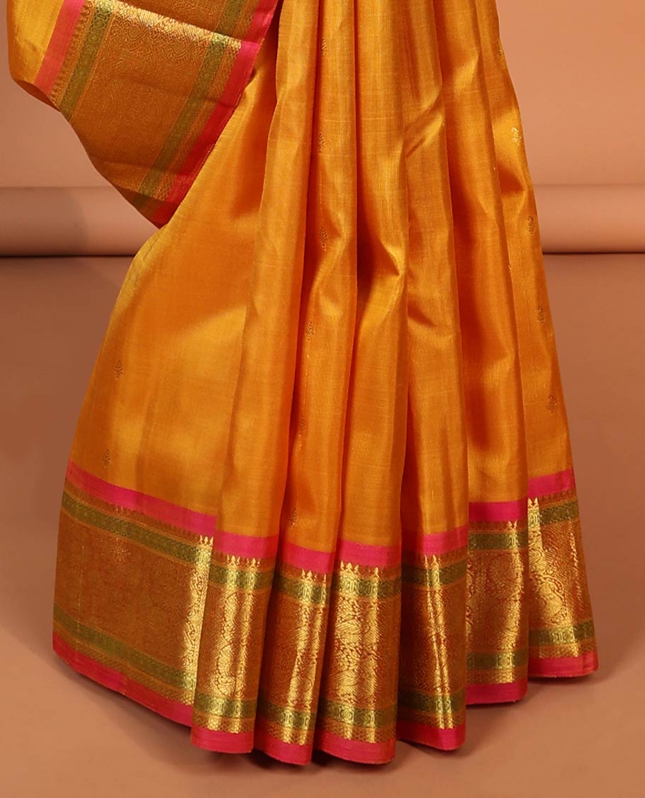 Orange leaf buttas kancheepuram silk saree with contrast border of sombu, paun, mayil design & zari design pallu