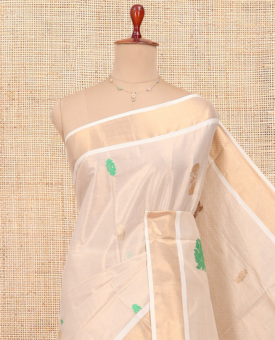 Cream Kerala Cotton Saree, Adorned with Thread and Zari Buttas All Over Its Body, a Zari Bavanji Border, an Intricate Pallu, and Paired with a Matching Blouse