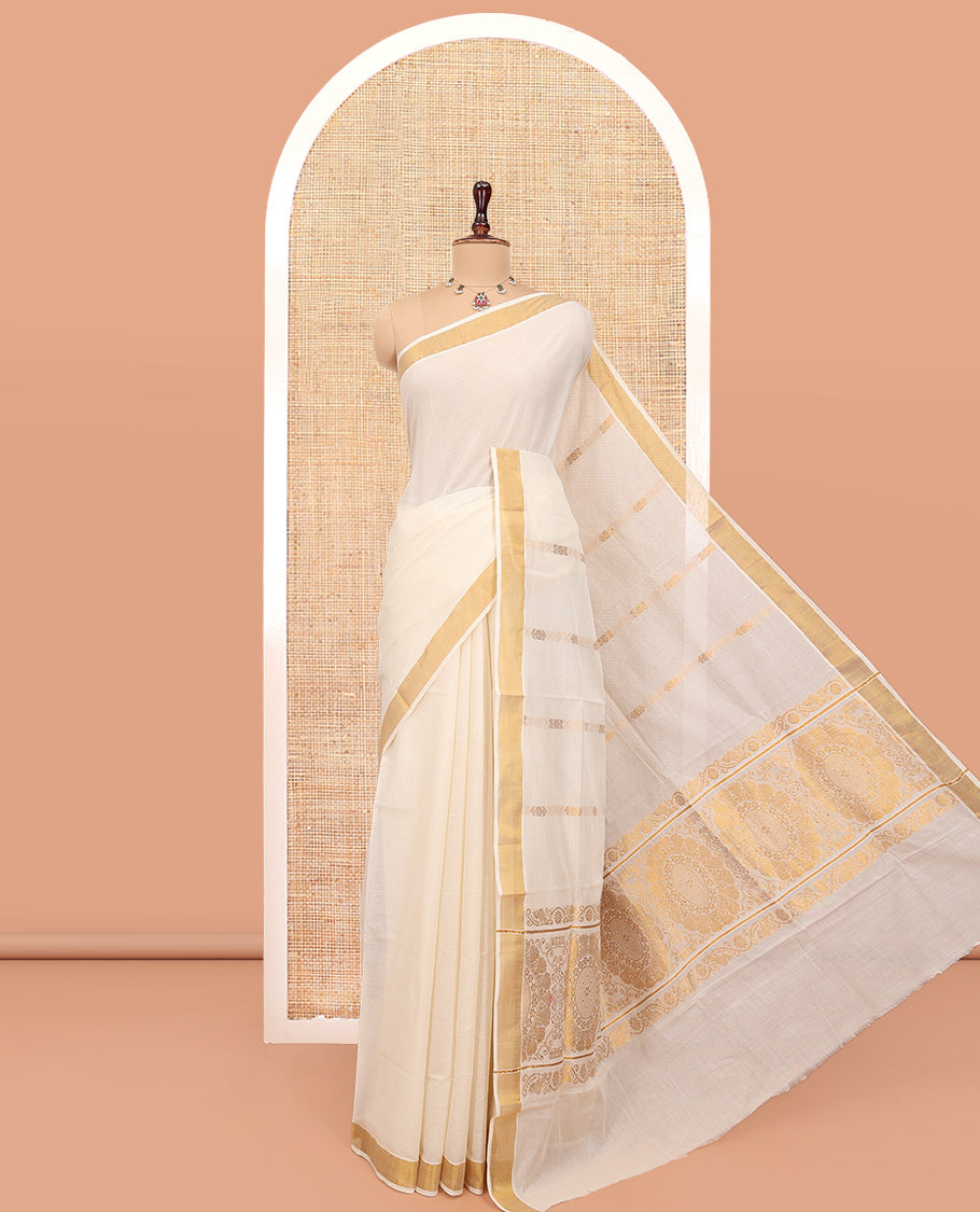 Cream Kerala Cotton Saree, Decorated with Zari Stripes All Over Its Body, a Subtle Bavanji Border, Pallu Features Chakram Designs, and Is Paired with a Matching Blouse