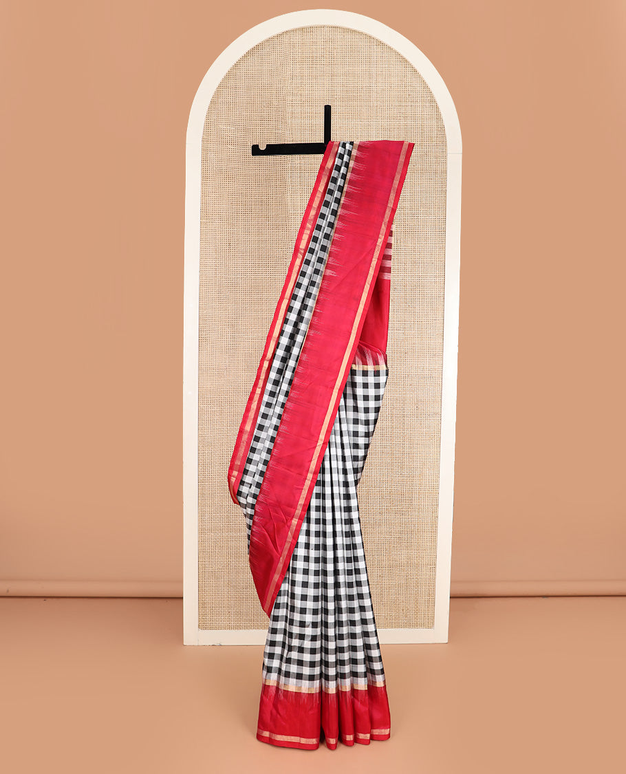 Black and white checked silk saree, contrast rettai pettu zari striped border, and pallu of geometric designs