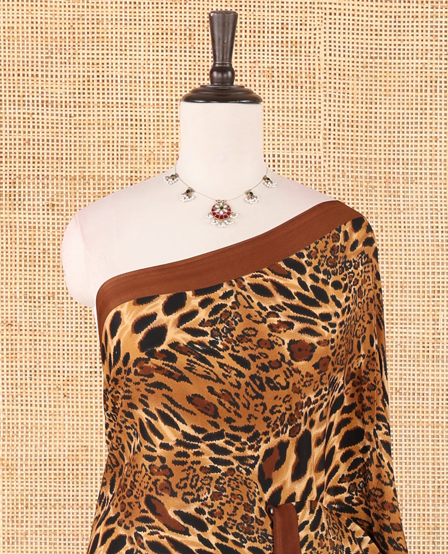 Brown leopard-skin-like printed crepe silk saree, plain piping border, geometric motif printed pallu & animal-skin print blouse