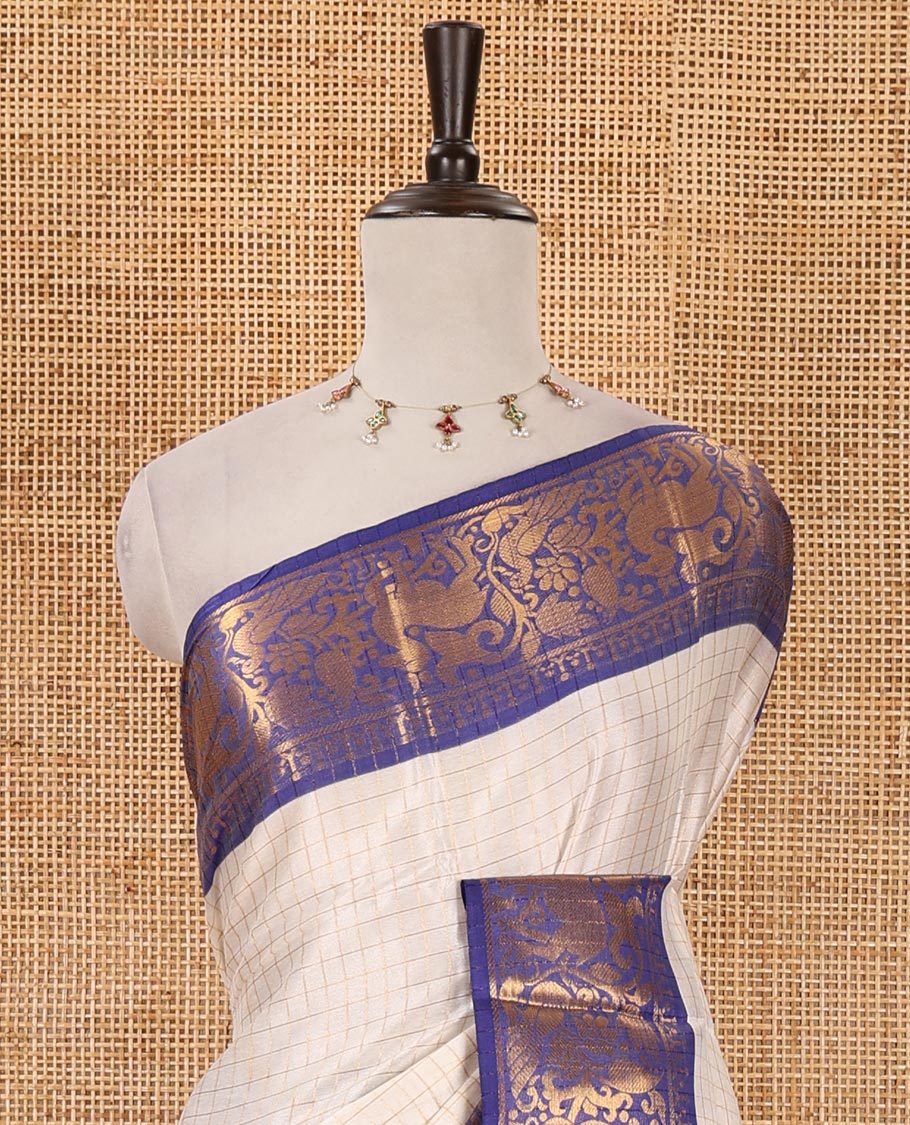 Half-white zari checked semi-taffeta silk saree, contrast deer motifs zari woven border, striped pallu & contrast striped zari border blouse