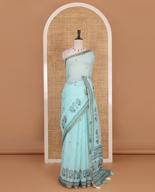 Sea green buttas with mirror work linen saree, zari border with peacock motifs print, printed mirror work pallu, and matching blouse