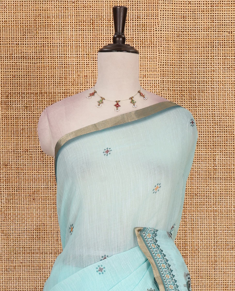 Sea green buttas with mirror work linen saree, zari border with peacock motifs print, printed mirror work pallu, and matching blouse