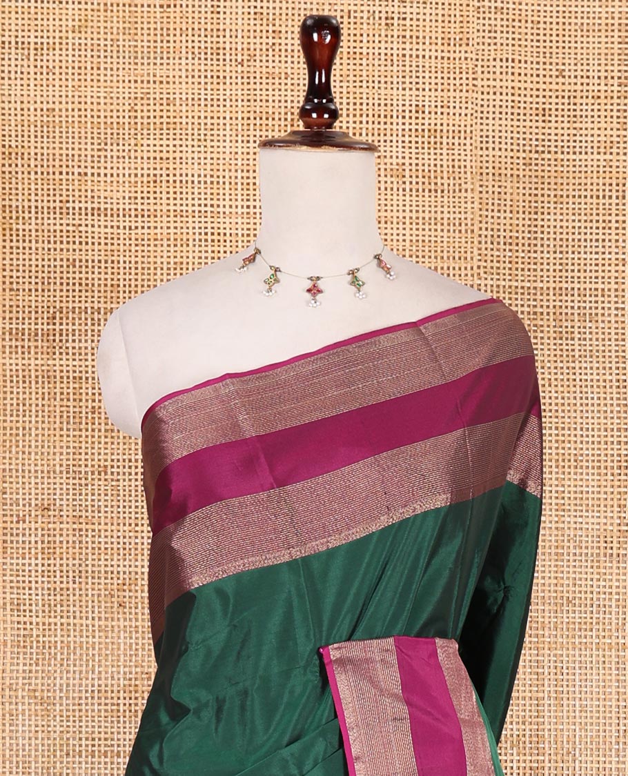 Dark green plain semi-soft silk saree, contrast zari striped border, striped pallu, and matching blouse