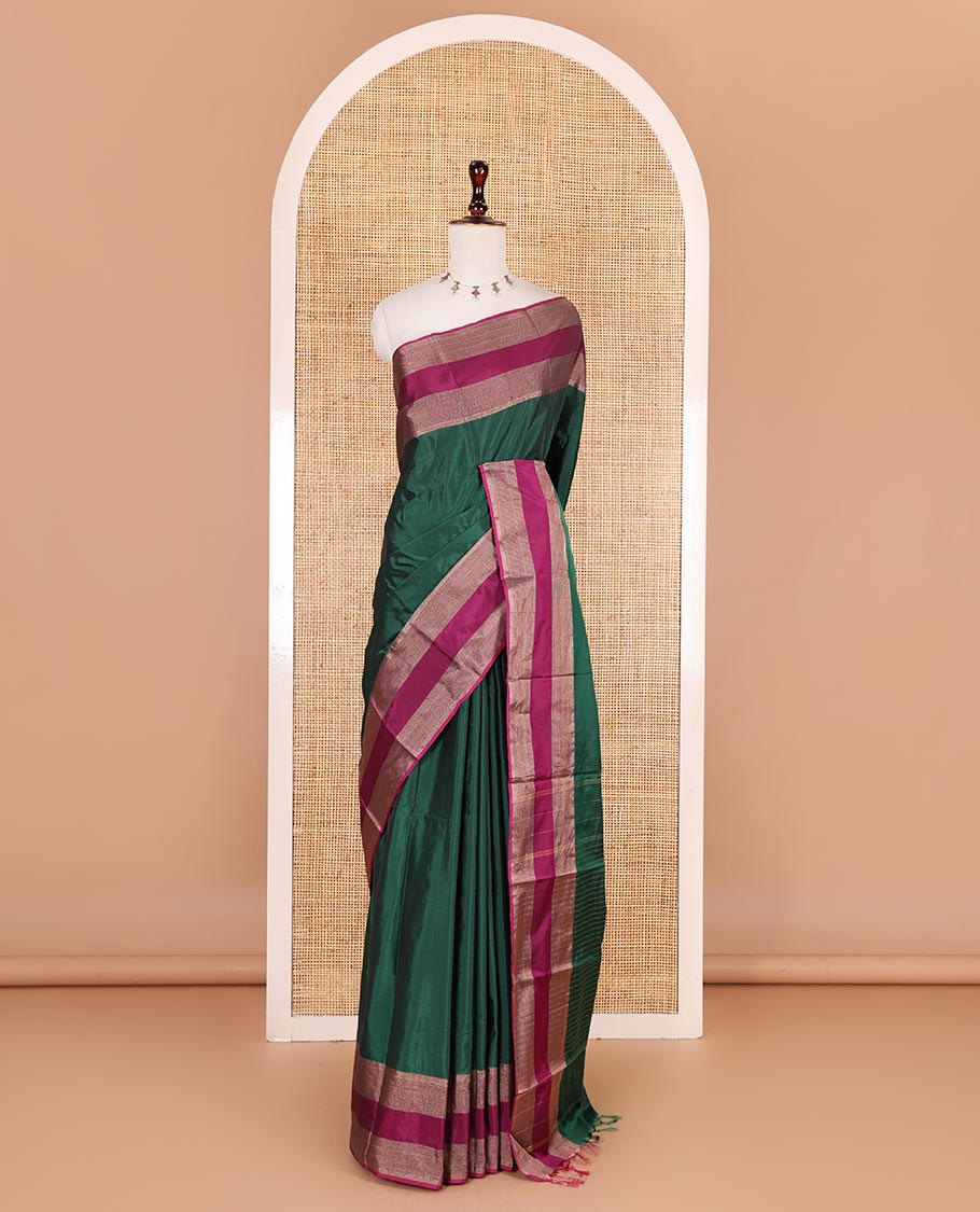Dark green plain semi-soft silk saree, contrast zari striped border, striped pallu, and matching blouse