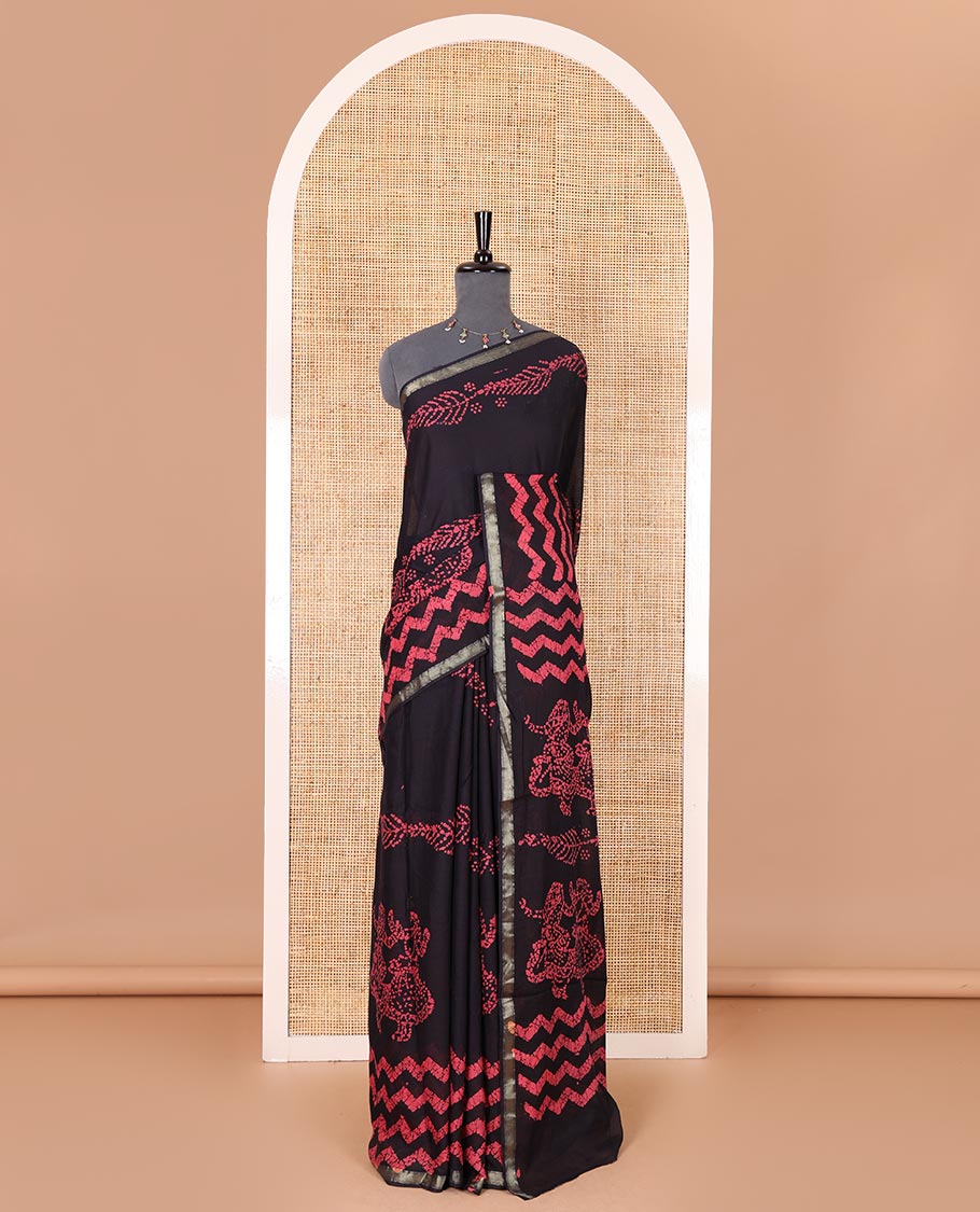 Ink blue wax batik-style zig-zag printed pure cotton saree, gold zari piping border, human figurines batik printed pallu, and a matching blouse