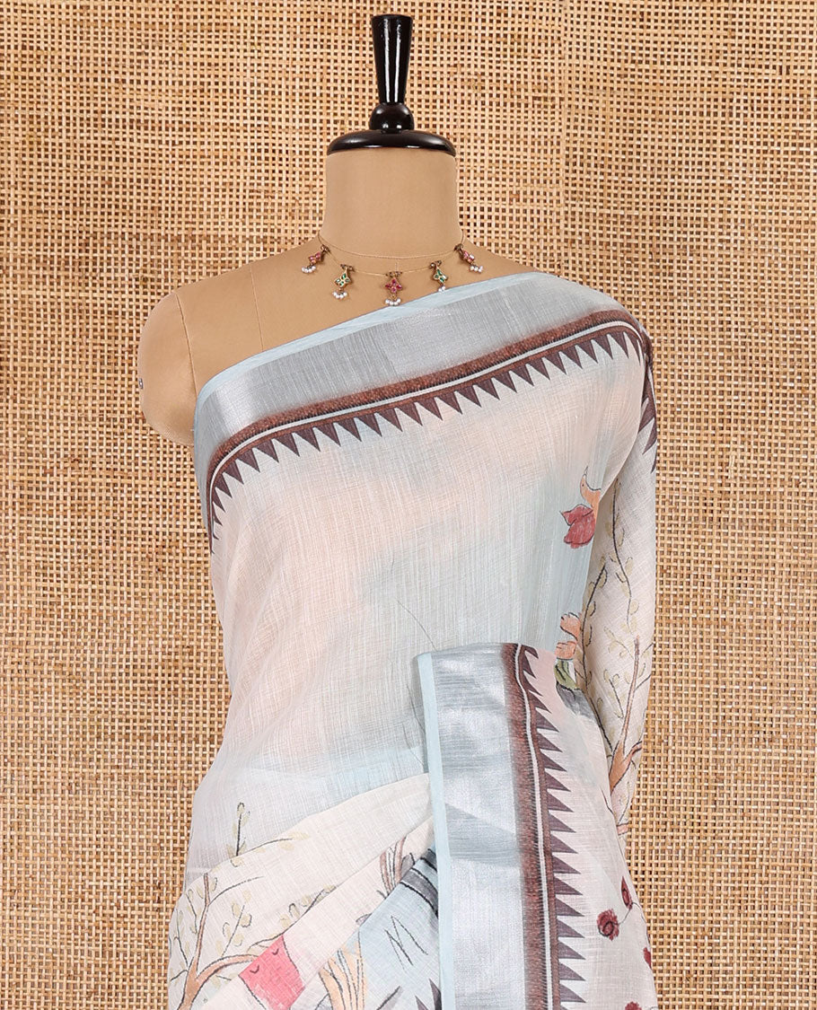 Sky blue nature-theme printed linen cotton saree features flora-fauna motifs, temple bavanji border, nature printed pallu, and a floral motif printed blouse