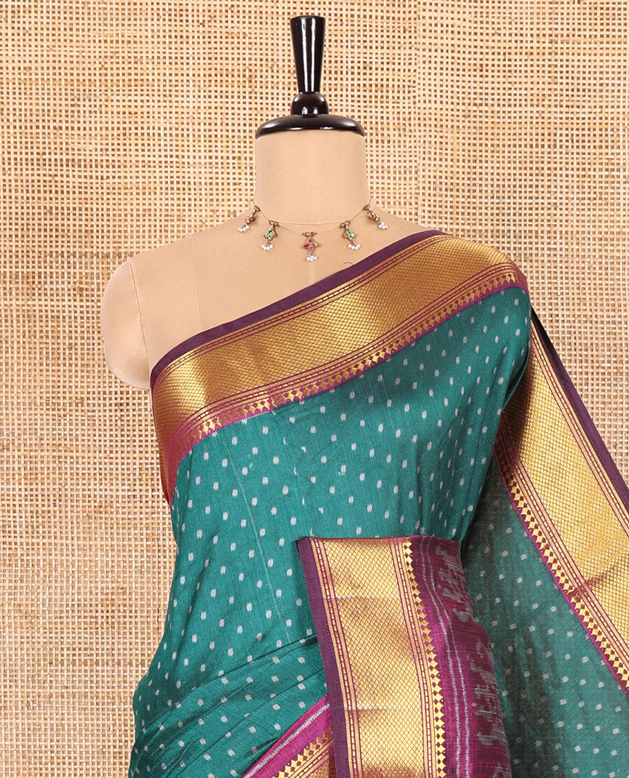 Peacock Green Patola Saree Subtly Sparked with Ikkat Style Polka Dots and Elephant Buttas, Complemented by a Contrast Traditional Zari Design Border, Featuring Pallu Steeped with Elephant Motifs, and Paired with a Contrast Blouse