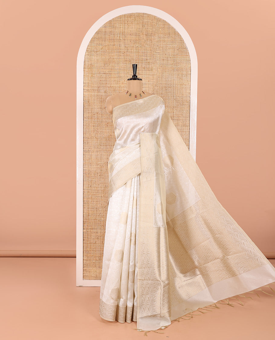 Cream Semi Tussar Saree Embellished with Floral Vine Embossed and Zari Buttas, Gleaming Border of Geometric Designs, Pallu Majestically Detailed with Geometric Designs in Zari, and Paired with a Matching Blouse