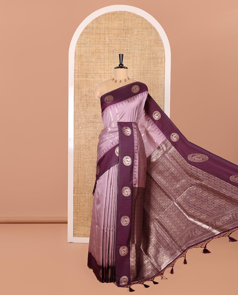 Lavender Elite Soft Silk Saree, Richly Detailed with Zari Buttas and Zari Stripes All Over Its Body, Complemented by a Contrast Temple Border of Round Peacock Designs, Rich Pallu of Peacock Chakram Butta Enclosed Checks, and Paired with a Contrast Blouse