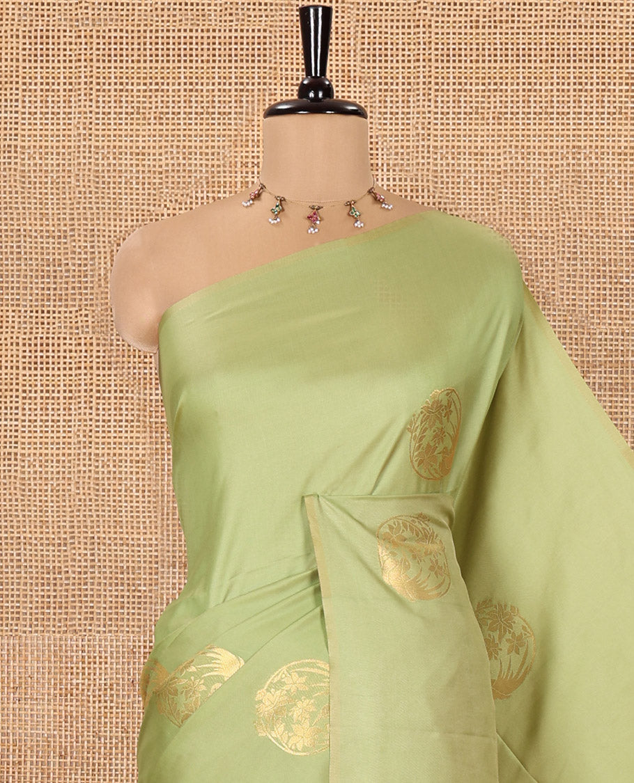 Borderless Green Semi-Soft Silk Saree Adorned with Bird-Floral Buttas All Over Its Body, Complemented by a Contrast Intricately Designed Pallu, and Paired with a Contrast Plain Blouse