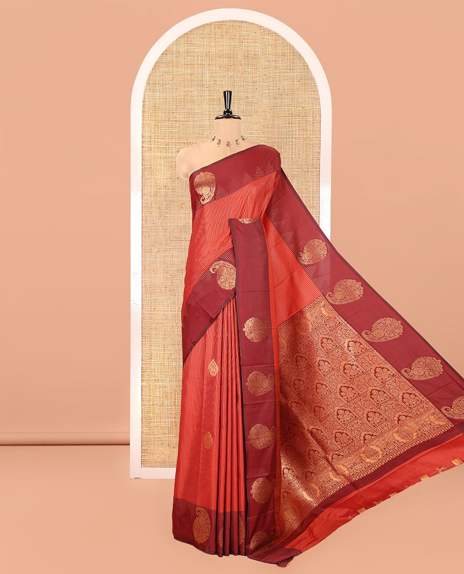 Reddish Brown Kanchi Soft Silk Saree, Majestically Detailed with Vaira Oosi, and Zari Buttas All Over Its Body, Complemented by Contrast Border of Paisleys, an Intricately Designed Pallu, and Paired with a Contrast Blouse