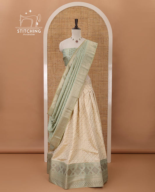 Cream semi-banaras material chudidar,leheriya zari skirt,contrast pista green zari & swarovski stonework border,jacquard blouse & zari weave dhavani