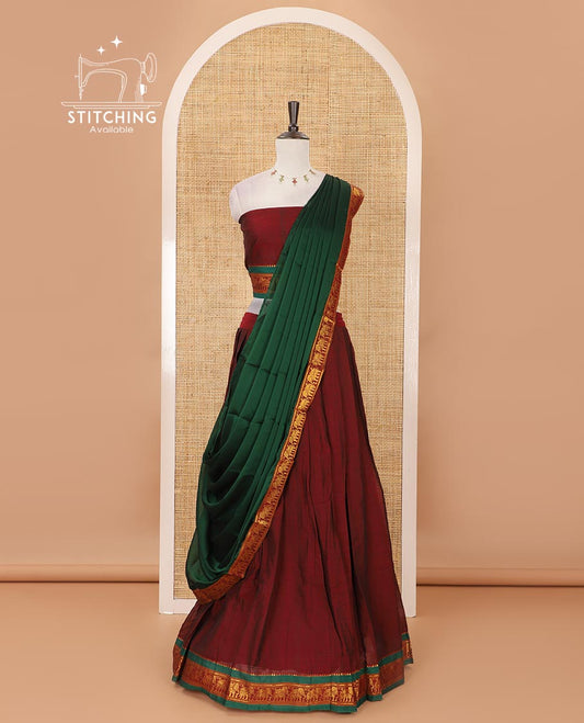 Maroon mercedised cotton half-saree, plain contrast elephant zari border skirt, matching blouse & contrast green zari elephant border dhavani