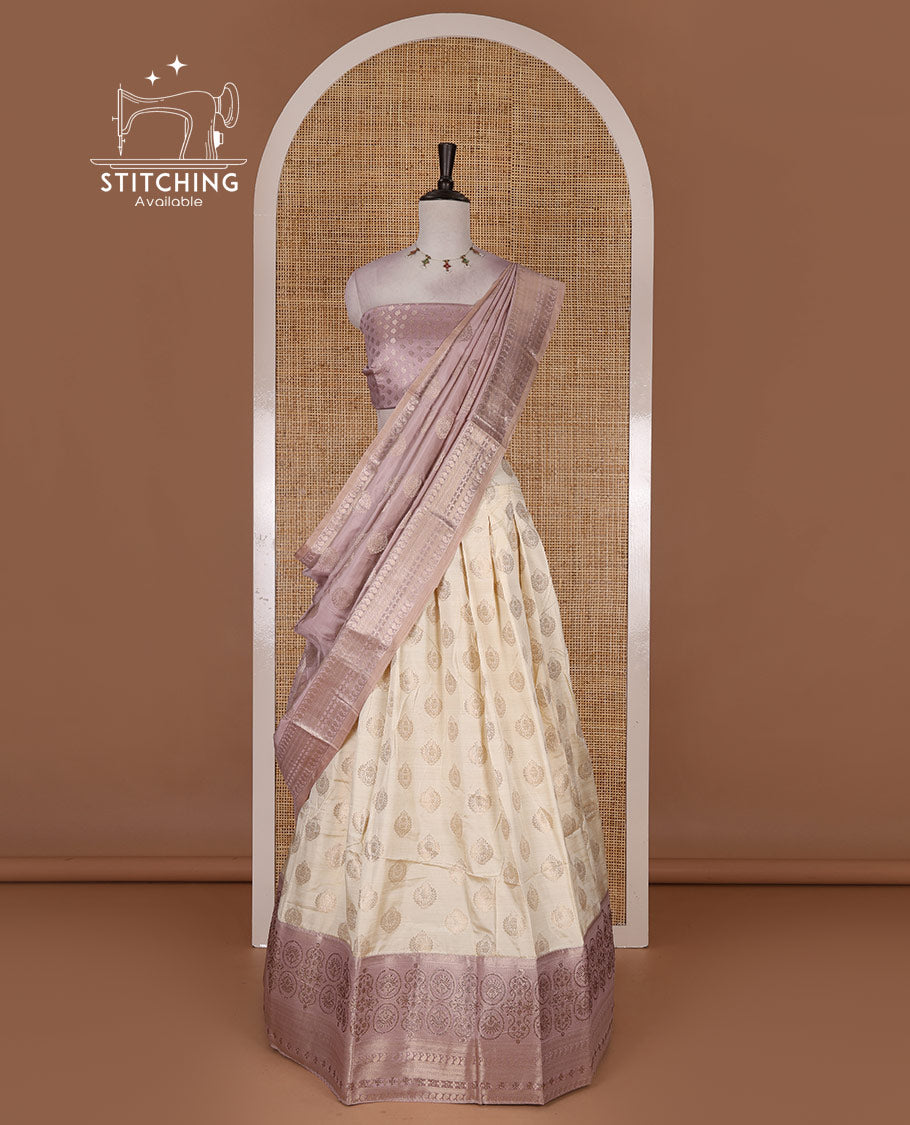 Cream and lavender semi-banarasi half-saree, zari buttas with contrast swarovski stone work border skirt, contrast zari buttas blouse, and intricate zari dhavani