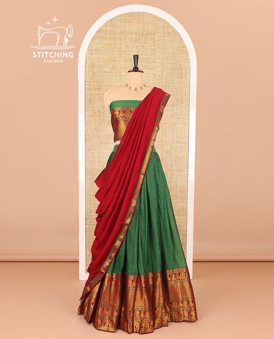 Green half-saree, plain with contrast traditional zari border skirt, matching zari bordered blouse, and contrast zari bordered dhavani