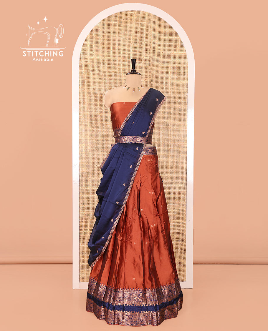 Rust and Blue Semi-Banarasi Half-Saree, Accentuated with Zari Buttas on Its Skirt, Complemented by a Contrast Rettai Pettu Traditional Zari-Design Border, Paired with a Matching Blouse, and Comes with a Contrast Satin Georgette Embroidered Dhavani