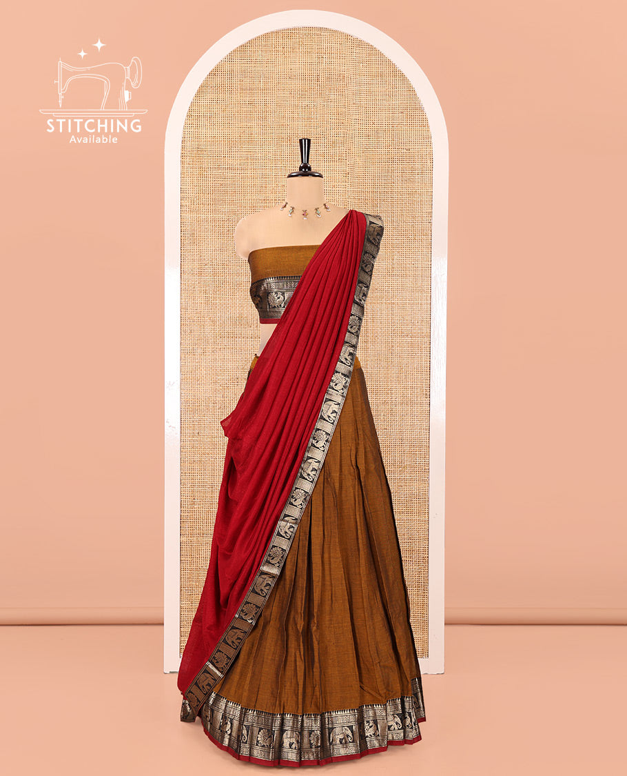 Mustard-Red Mercerised Cotton Half-Saree Features Plain with Contrast Traditional Zari Bordered Skirt, Paired with a Matching Blouse, and Comes with a Contrast Bordered Dhavani