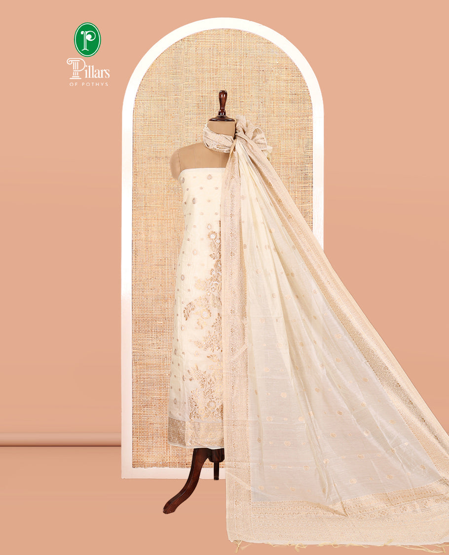 Kerala Cream Banarasi-Silk Material Churidar, Adorned with Floral Designs Top, a Plain Bottom, and Zari Design Dhavani