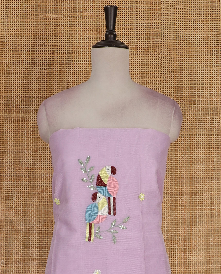 Lavender net kota material chudidar set, macaw parrot, and flower motifs, multi-color sugar bead embroidered top, plain santoon bottom, and sugar bead embroidered dupatta