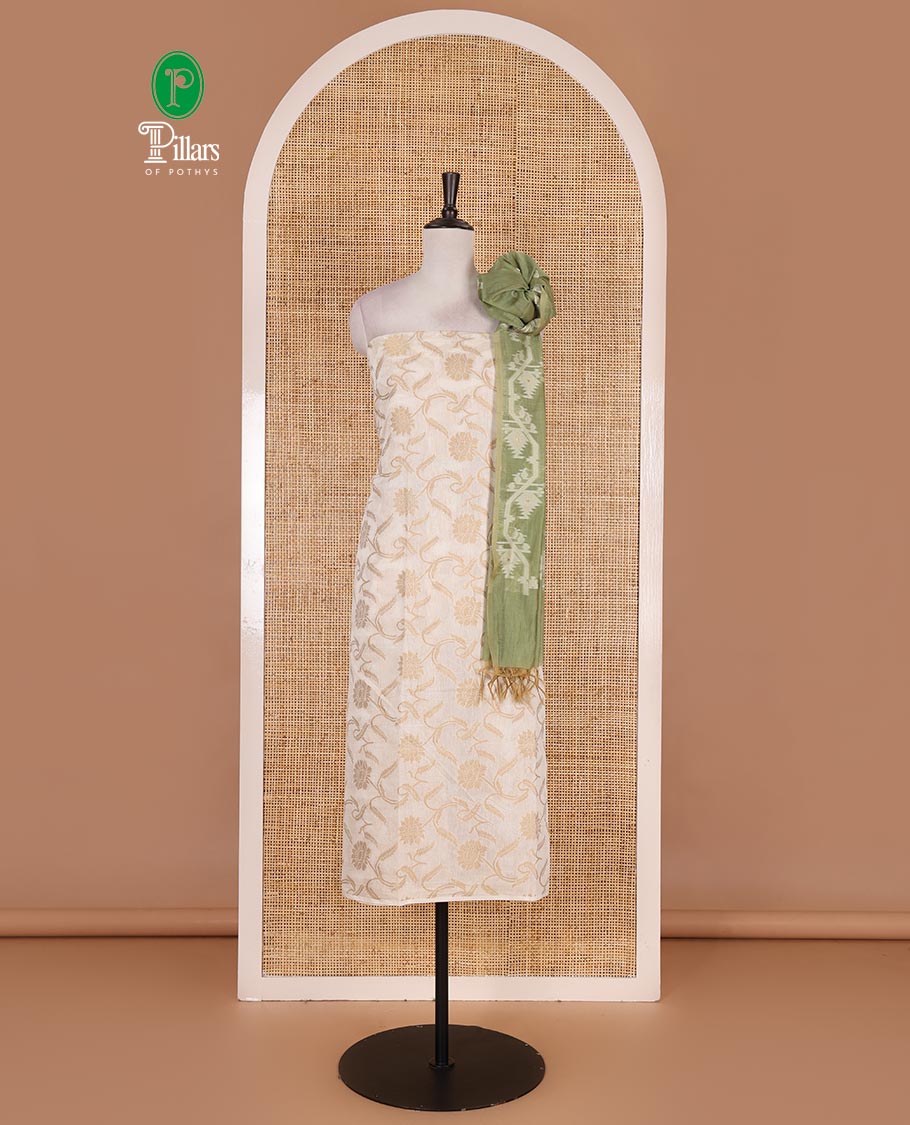 Cream with pista green semi-chanderi material churidar set, floral jaal jacquard top, contrast taffeta silk bottom, and jamdani style dupatta