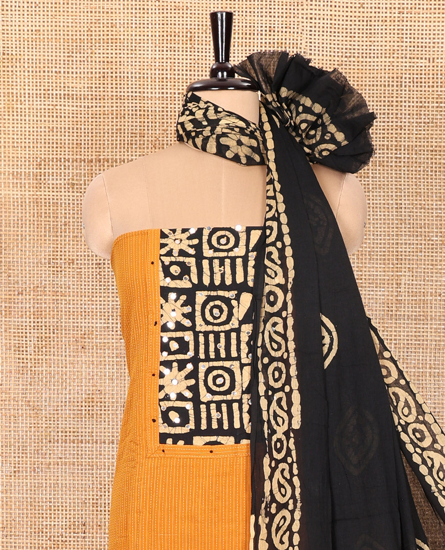 Mustard Material Chudidar Set Beautified with Kantha Embroidery, Batik Print, and Mirror Work on the Cotton Top, Comes with a Batik Geometric Patterns Printed Bottom, and a Cotton Batik Geometric Printed Dupatta