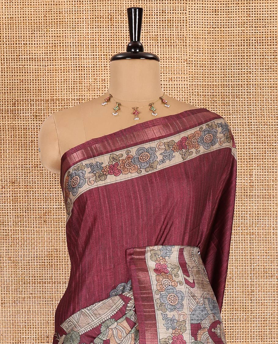 Maroon kalamkari human figurines printed fancy tussar saree, floral printed border, human figurines printed pallu, and a matching blouse