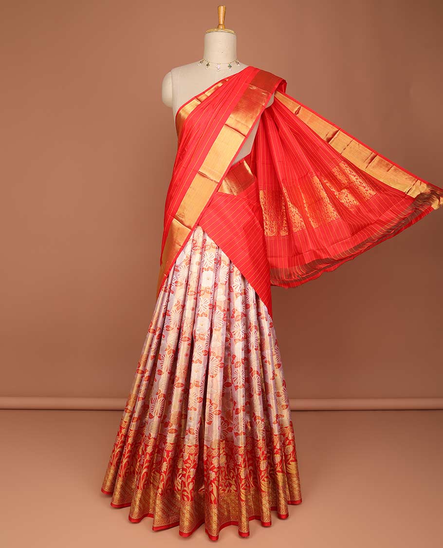 Light orange floral jacquard pure silk half saree with contrast floral zari design border, zari design blouse & floral zari design dhavani