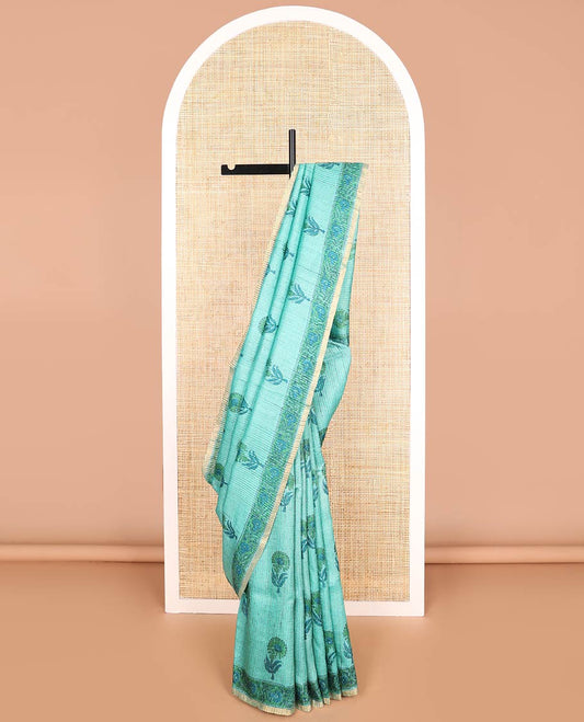 Light blue flower motifs tussar saree with contrast floral design border & floral design pallu