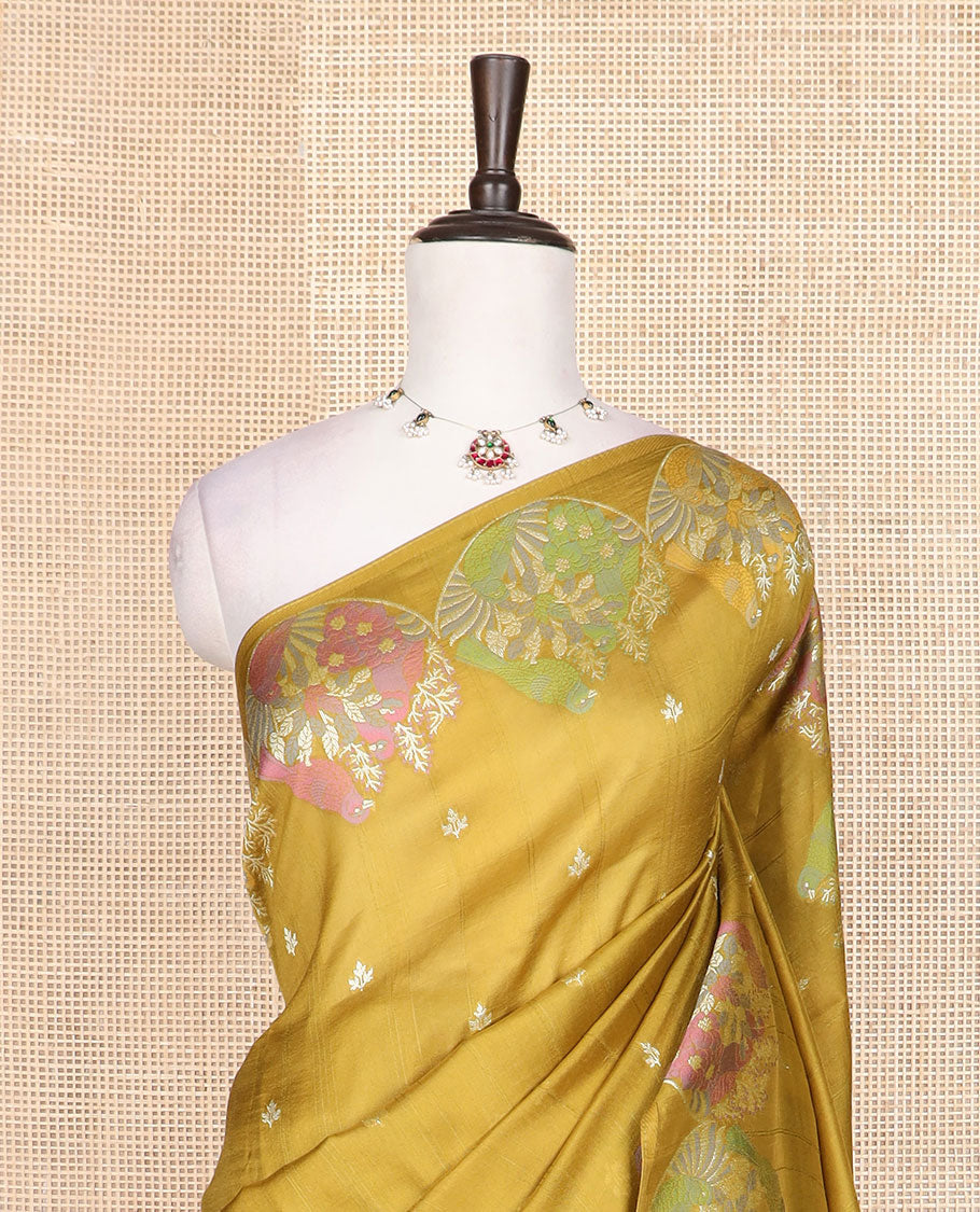 Borderless mustard Matka silk saree features floral and scallop bird motifs in meenakari style