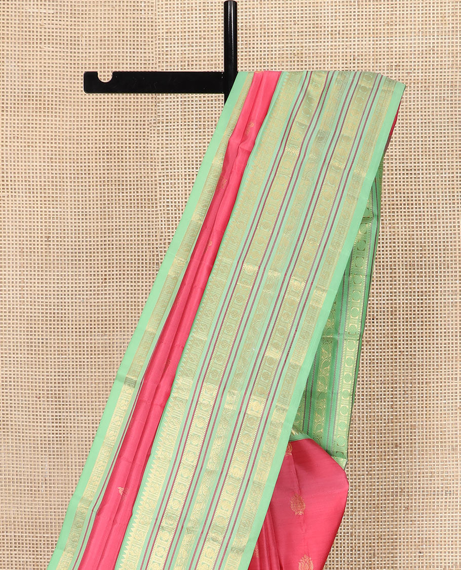 Red Vasundhara Silk Saree Subtly Woven with Zari Buttas, Complemented by a Contrast Varisai Pettu Border of Rekku, Mayil, Rudraksham, and Manga Designs, Pallu Adorned with Traditional Designs, and Paired with a Contrast Zari-Bordered Blouse