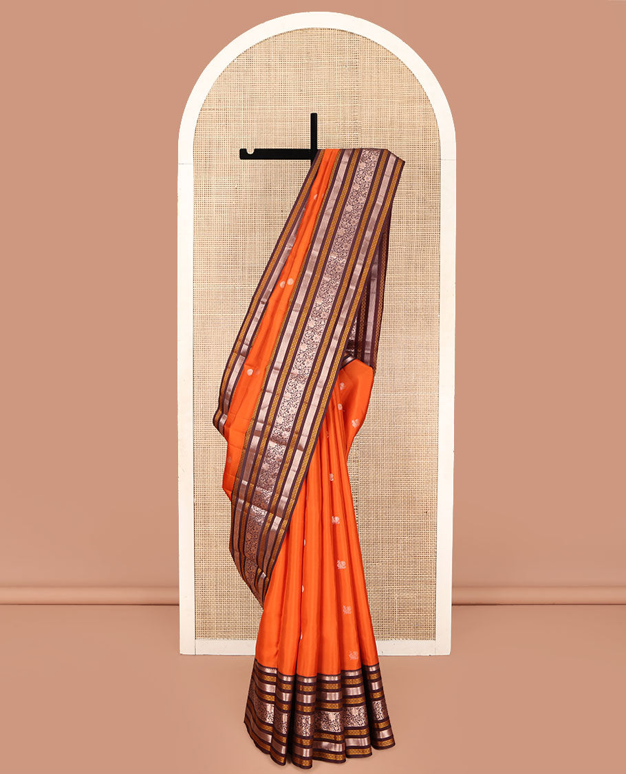 Orange Vasundhara Silk Saree, Adorned with Annam Chakram Buttas All Over Its Body, Complemented by Contrast Border of Thilakam, Neli, Laddu Kamalam, Mayil Kann, and Kodi Visiry Designs, Pallu of Butta Enclosed Checks, and Paired with a Contrast Blouse