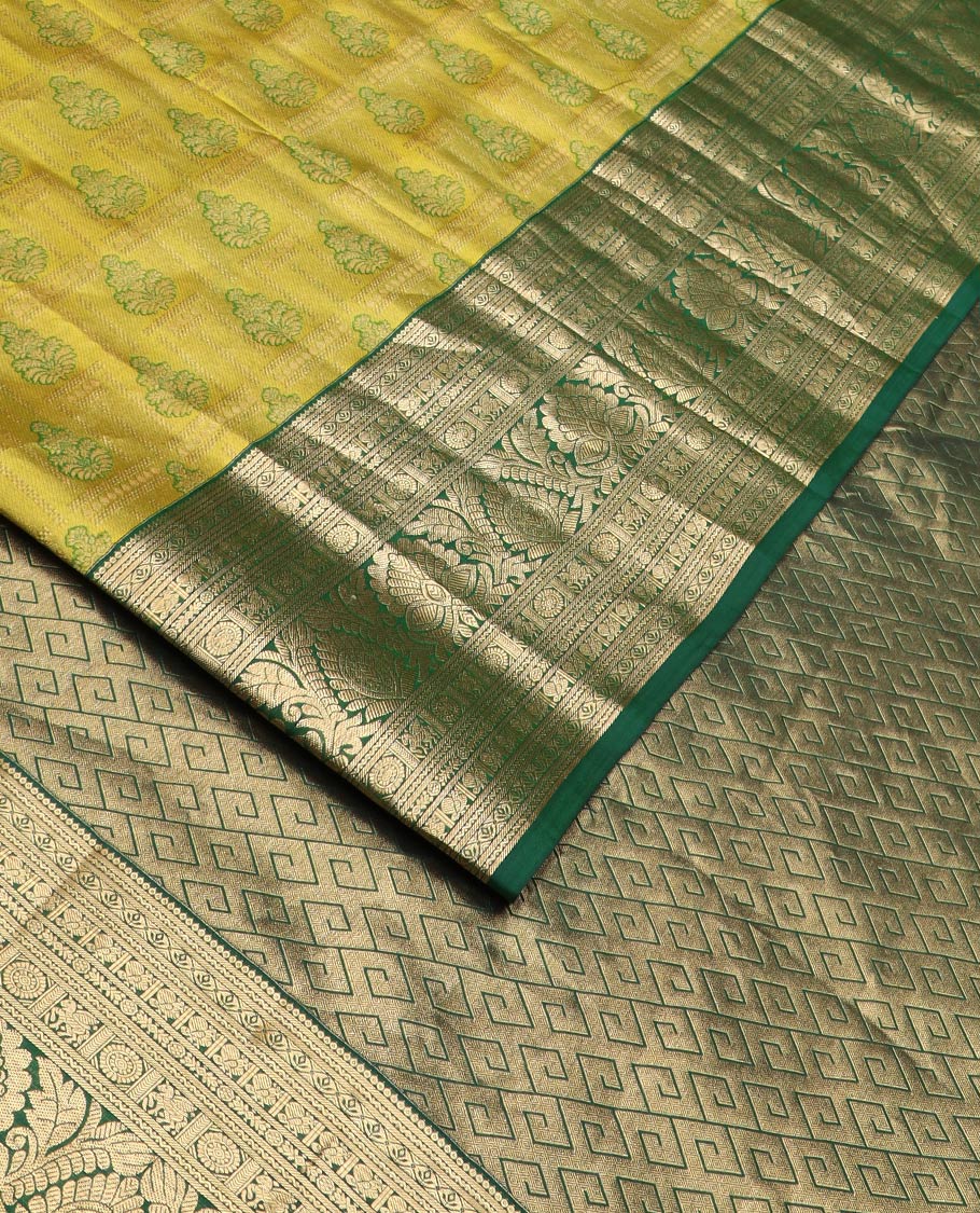 Green jacquard Kanchipuram wedding silk saree, contrast border of thilakam, banaras, neli, mayil, kuthirai, chakram, and zari designs, and geometric patterned pallu