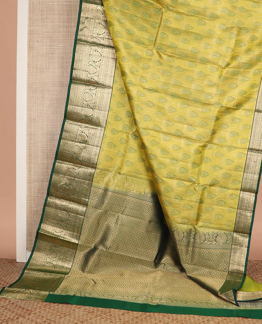 Green jacquard Kanchipuram wedding silk saree, contrast border of thilakam, banaras, neli, mayil, kuthirai, chakram, and zari designs, and geometric patterned pallu