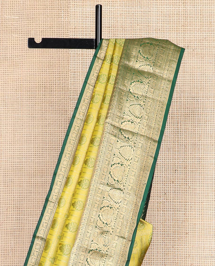 Green jacquard Kanchipuram wedding silk saree, contrast border of thilakam, banaras, neli, mayil, kuthirai, chakram, and zari designs, and geometric patterned pallu