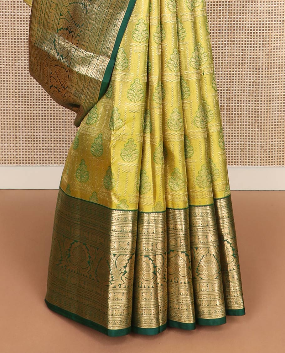 Green jacquard Kanchipuram wedding silk saree, contrast border of thilakam, banaras, neli, mayil, kuthirai, chakram, and zari designs, and geometric patterned pallu