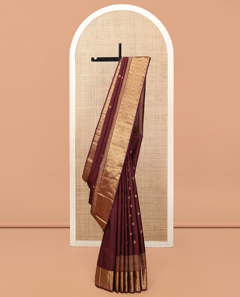Brown Kanchipuram Silk Saree, Adorned with Zari Buttas, a Zari Border of Iruthalai Pakshi, Thilakam, Kathir, Mayil, Yaanai, and Mayil Kann Designs, Jaal Pallu, and a Matching Blouse